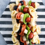 Looking for a fun appetizer or creative lunch box addition? Pasta Salad on a Stick takes all the classic pasta salad ingredients and threads them on a long toothpick for a delicious new spin. Perfect for parties and afternoon snacks alike.