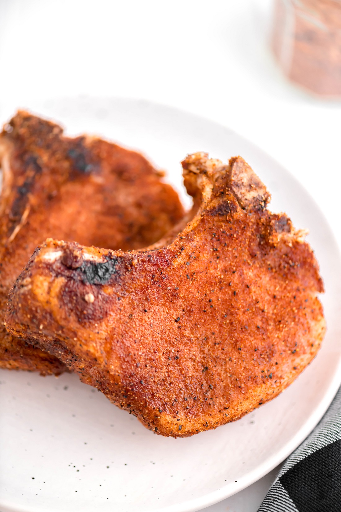 Warm weather means it's time to break out the smoker. These Smoked Pork Chops are super simple to make and done in less than 2 hours.