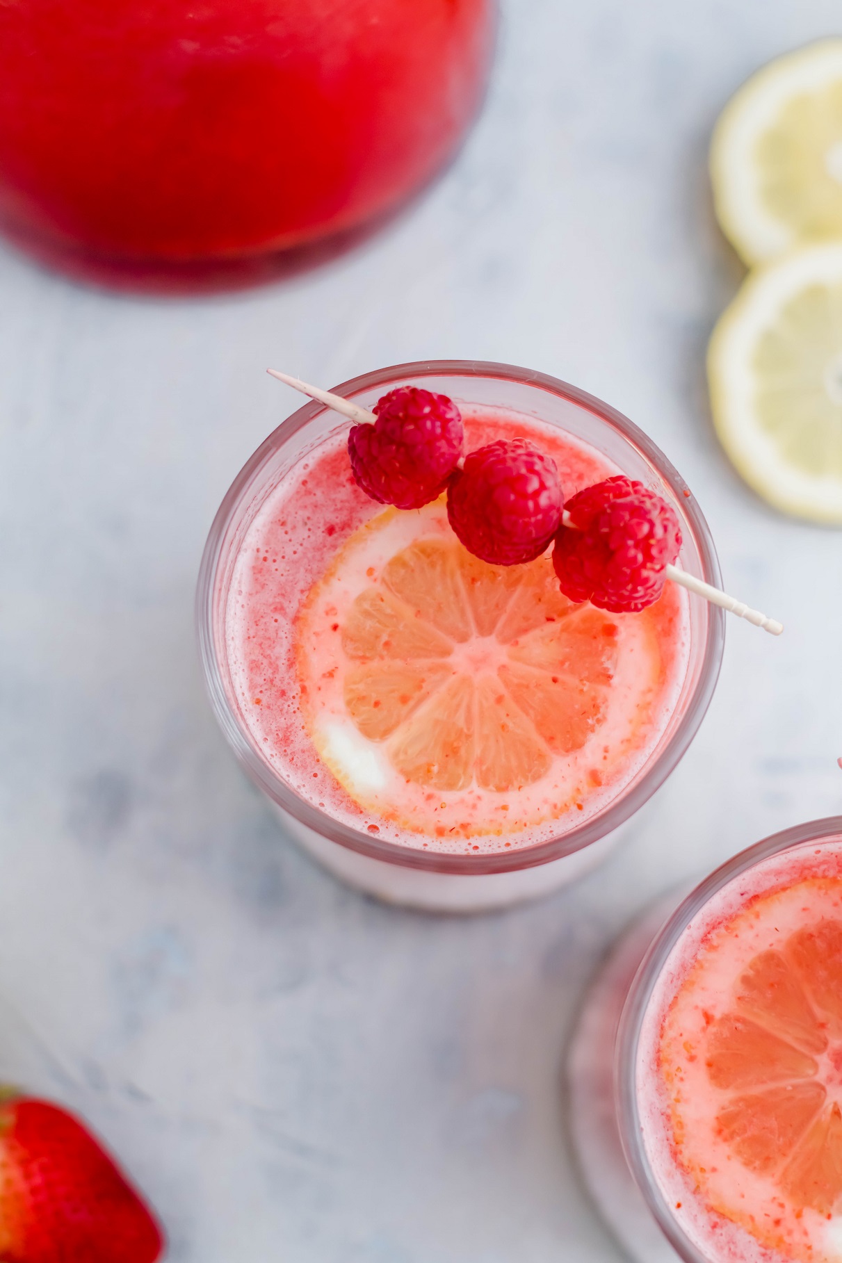 The drink of summer has arrived. Pink Lemonade Vodka Punch is so fruity and refreshing. Make a big batch for your next party. It's officially time for all the refreshing, fruity, summery drinks. This Pink Lemonade Vodka Punch is SO simple to make and fulfills all those requirements. Pureed strawberries and raspberries provide so much fruity flavor while the lemonade brings some delicious zippiness. Get ready for the perfect summer drink.