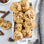 Kit Kat Cookies piled in a white baking dish. Bowl of kit kats in background.