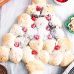 You'll be the hit of the party when you arrive with this gorgeous Christmas Tree Bread featuring Rhodes bread dough and creamy chocolate hazelnut spread. Easy to make and sure to impress!