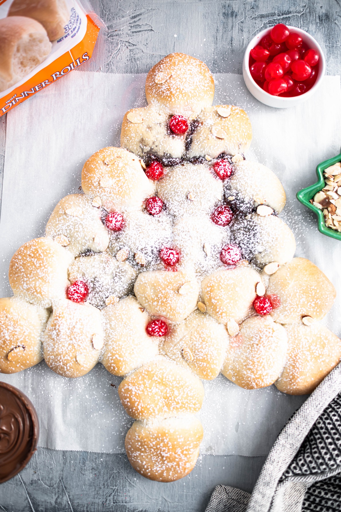 You'll be the hit of the party when you arrive with this gorgeous Christmas Tree Bread featuring Rhodes bread dough and creamy chocolate hazelnut spread. Easy to make and sure to impress!