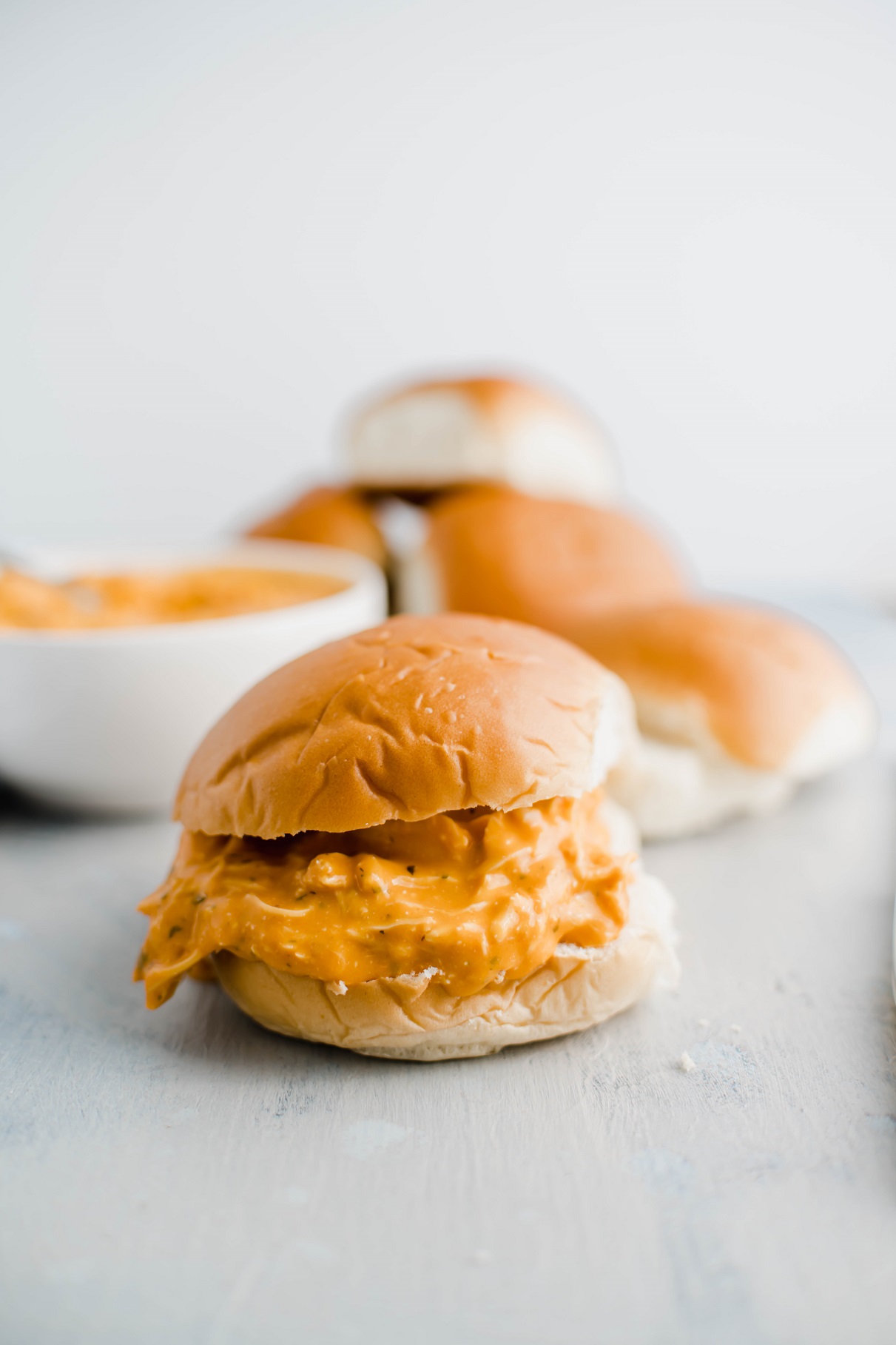 Close up of shredded buffalo chicken sandwich.