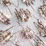 Peppermint bark almond clusters on parchment paper.