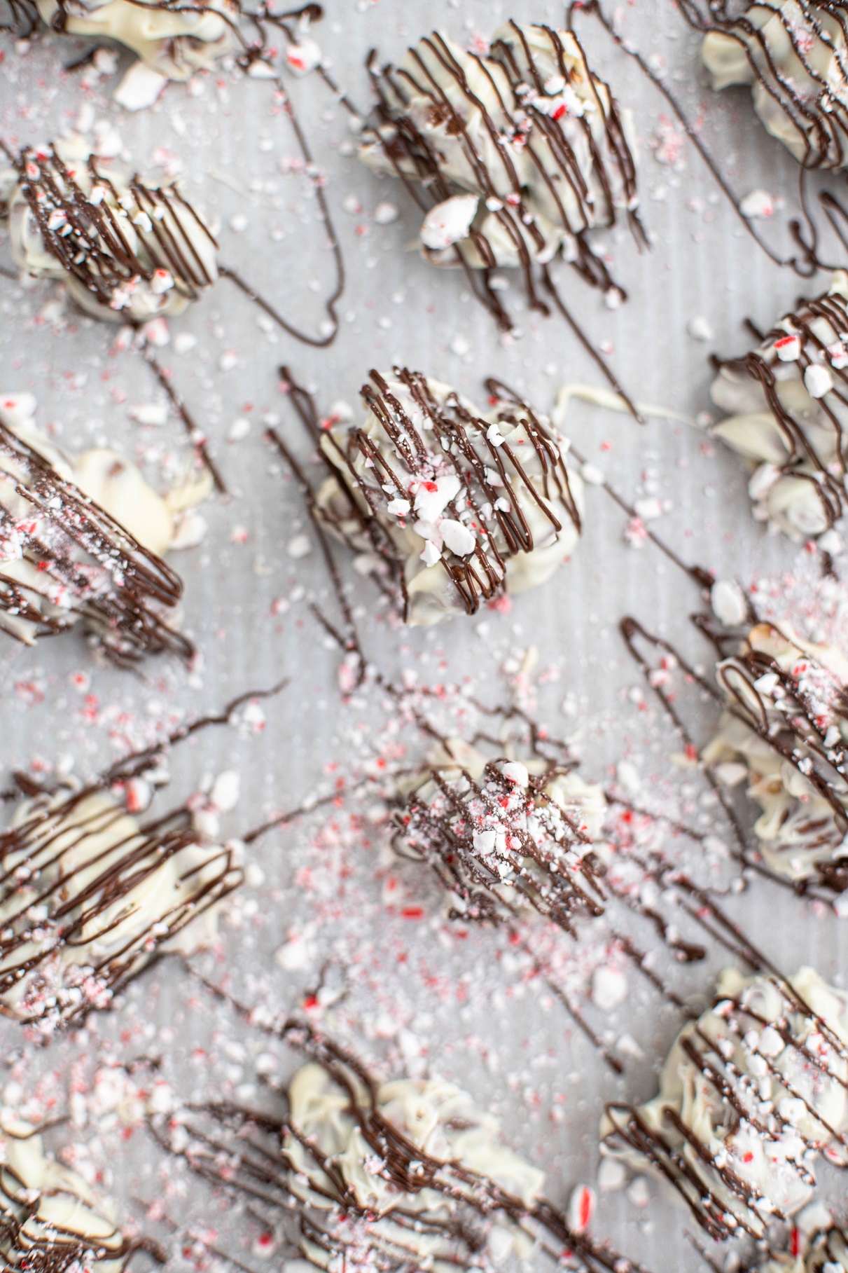 Peppermint bark almond clusters on parchment paper.