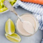 Jar of salsa ranch surrounded by fresh veggies.