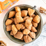 Vintage pie plate filled with cinnamon sugar donut holes.