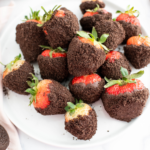 Oreo Chocolate Covered Strawberries piled on a round white plate.