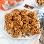 White hexagon platter filled with easy sticky buns.