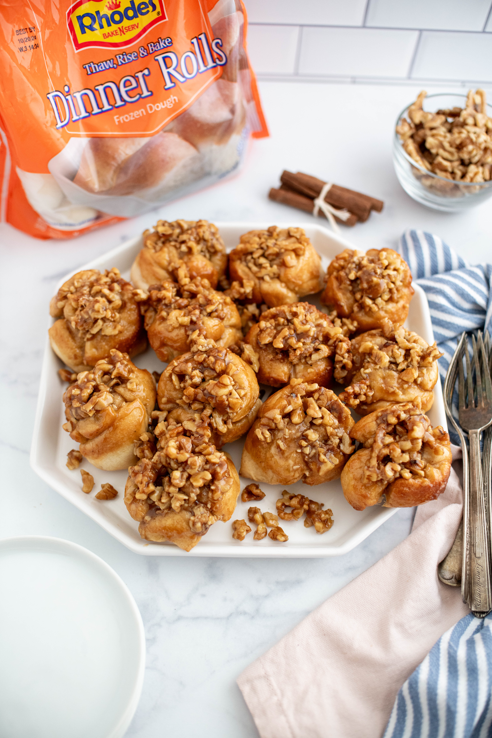 White hexagon platter filled with easy sticky buns.